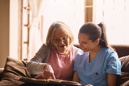 Bringing history alive. a nurse and a senior woman looking at a photo album together.