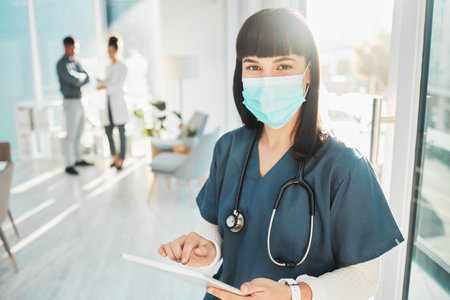 Covid, research and portrait of a doctor with a tablet for medicine, communication and schedule. Healthcare, internet and female nurse with a face mask for virus and technology for nursing agendaの写真素材