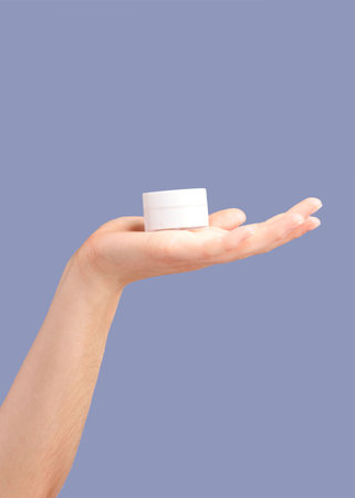Hands, skincare and cream container in studio isolated on a purple background for hydration. Cosmetics, dermatology and woman or female model with lotion, creme or moisturizer for beauty aesthetics.の写真素材