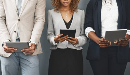 Might as well make connections while waiting. a group of unrecognisable businesspeople using their...