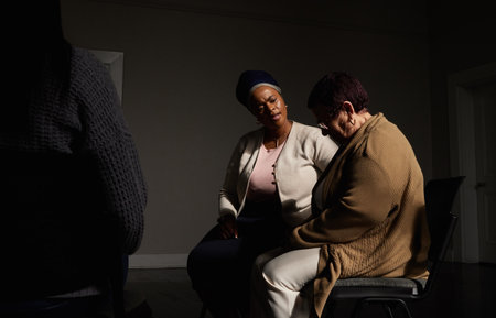 Support, therapist and black woman in group therapy, understanding and sharing, talking at session. Mental health, addiction or depression, help for people in grief with psychiatrist sitting togetherの写真素材