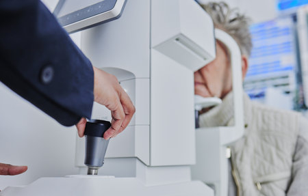 Ophthalmology, medical and eye exam with patient and doctor for healthcare, vision or consulting. Technology, medicine and optometry with senior woman and retinal screening for optician and treatmentの写真素材