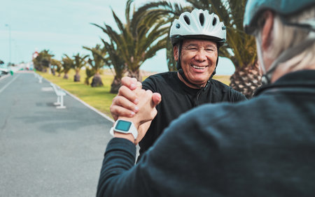 Roller skate, holding hands and senior couple smile in city for exercise, fitness hobby and skating activity. Retirement, wellness and happy elderly man helping woman for balance, training and sportsの写真素材
