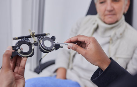 Optometrist hands, test glasses and senior woman for health advice and helping hand in consultation...