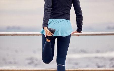 Fitness, outdoor and woman stretching her legs before running or training by the promenade. Sports,...