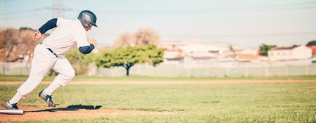 Baseball, sports and fitness fast run of a sport player running on outdoor field in a game. Training, workout and exercise of a young athlete with focus and freedom from runner speed in the sunの写真素材