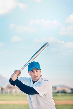 Sports, baseball and portrait of man with bat on field ready to hit ball in game, practice and competition. Fitness, focus and male athlete outdoors for exercise, training and workout for sport matchの写真素材