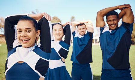 Cheerleader training or portrait of team stretching on a outdoor stadium field for fitness exercise. Cheerleading group, sports workout or happy people game ready for cheering, match or campus eventの写真素材