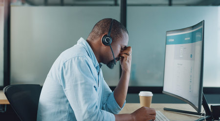 Call center, black man and headache on computer from stress, burnout and desktop glitch, pain and...