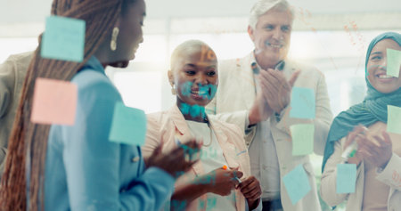 Black woman, leadership success and post it, applause for business meeting, goal planning strategy and corporate happiness in office. African business woman, leader achievement and employees teamworkの写真素材