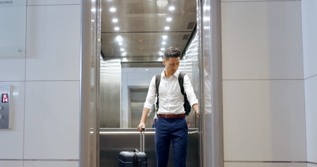 Elevator, travel and watch with a business asian man in an airport, checking the time of his flight...