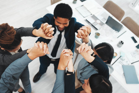 Collaboration, teamwork and above business people holding hands in support of vision, growth or training in office. Team building, group and hand unity in motivation, partnership or corporate startupの写真素材