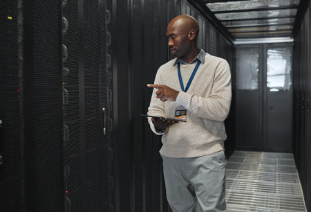 Tablet, network management and IT black man for software update, working on code in dark server...