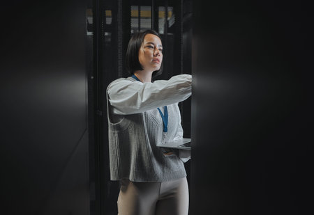 Laptop, maintenance or serious IT woman in server room for research, engineer in data center....