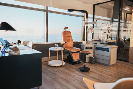Optometry, equipment and empty office of a doctor for work in ophthalmology, eye and vision care. Healthcare, surgery and room at a clinic for optician workspace, optometrist business and furnitureの写真素材