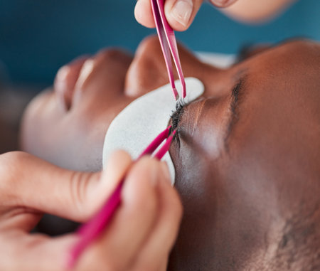 Spa woman face, hands and tweezers for eyelash extension, application or beauty salon healthcare. Cosmetics process, wellness service and relax African client, customer or patient for luxury lashesの写真素材