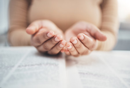 Worship, prayer and bible with hands of woman for religion, support and Christian faith. Believe, spirituality and God with girl praying over catholic holy text for wellness, respect and hopeの写真素材