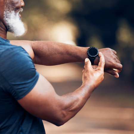 Smart watch screen, hands and outdoor for fitness and exercise time or performance. Senior black man with health app button to check heart, steps and clock or workout progress mockup in forestの写真素材