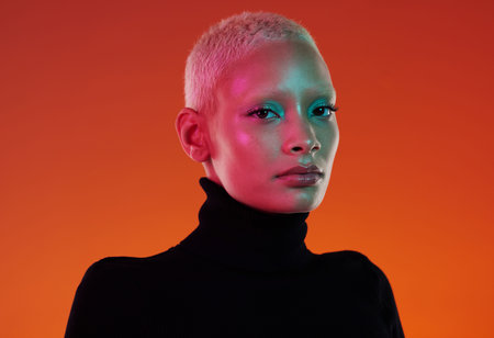 Face portrait, skincare and beauty of woman in studio isolated on a red background. Neon aesthetic,...