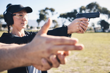 Man, woman and gun training with aim, outdoor target or hand position at police, army or security...