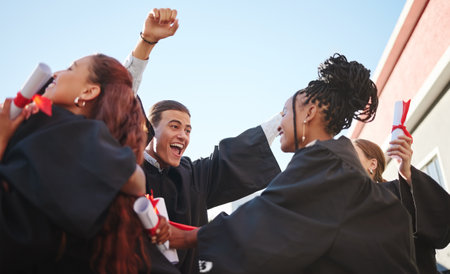 Celebration, happy and student graduation at a certificate, diploma and education success event. Students, friends and university students with happiness of a graduate, class and college achievementの写真素材