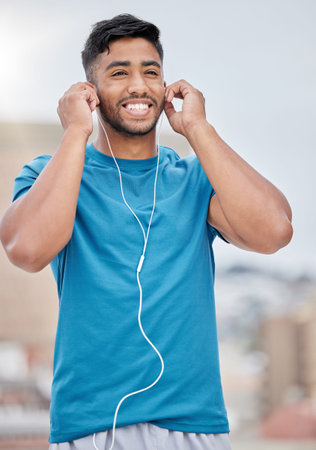Man, music and earphones for city exercise for wellness, training and running by blurred background....