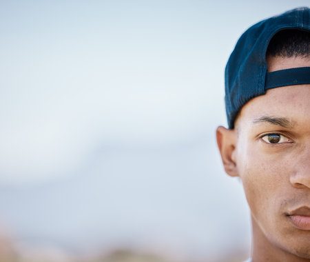 Portrait, half and mockup with a sports black man looking serious outdoor for fitness, exercise or training. Face, focus and mindset with a male athlete standing on blank mock up space outsideの写真素材