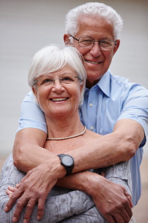 And they lived happily ever after. a happy senior couple standing outdoors while smiling at the camera.の写真素材