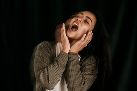 Crazy, bipolar woman crying, frustrated or anxiety on black studio mockup for psychology and mental health. Trauma, schizophrenia or depressed girl shout with depression, fear and mental illnessの写真素材