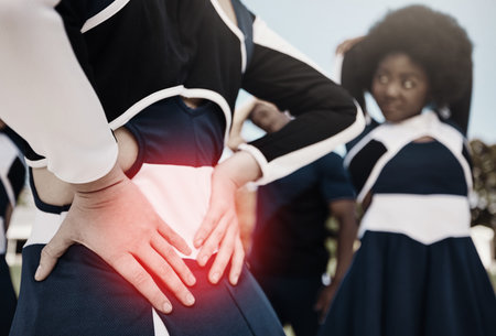 Cheerleader, sports or woman with back pain, injury or accident on field in game or training match....