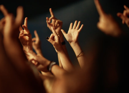 Feeling the music. A crowd of people raising their arms to the music.の写真素材