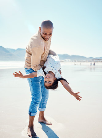 Family, beach and father carry girl playing by ocean for bonding, quality time and relaxing on weekend. Love, nature and happy dad holding child on summer holiday, vacation and adventure togetherの写真素材
