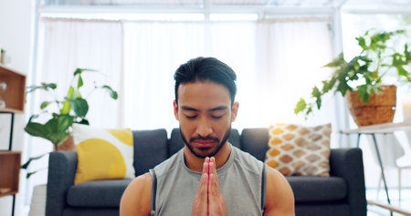 Yoga, man and lotus meditation in house, home or living room floor for health, fitness and wellness. Zen, mind relax and meditating male doing pilates to improve strength, flexibility and balance.の写真素材
