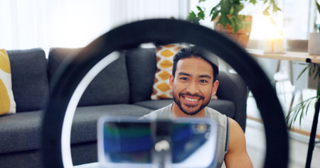 Influencer, fitness and training with a sports man live streaming or recording content for his...