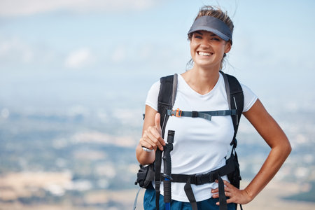 Hiker woman, hiking and thumbs up outdoor with smile in adventure portrait, travel and success trekking up mountain. Fitness, freedom and happy to win, backpacking and tourist in nature.の写真素材