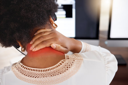 Black woman, neck pain and call center in back view with tired muscle, burnout stress and office computer. Crm consultant, workplace injury or customer service agent with strain, frustrated or hurtの写真素材