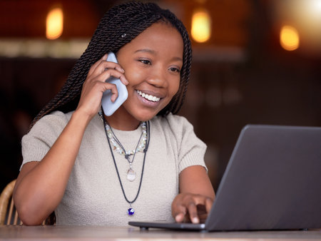 Black woman, phone call and laptop with smile for communication, conversation or discussion at cafe. Happy African American female freelancer smiling on mobile smartphone by computer in remote workの写真素材
