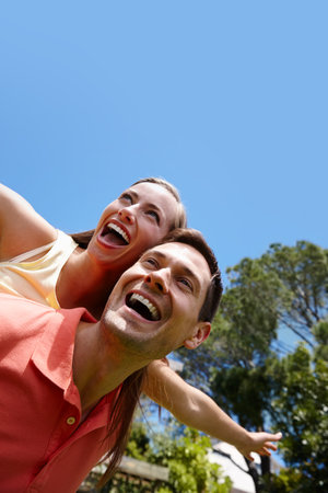 Best airline service she experienced. A young couple having fun outdoors on a sunny day.の写真素材