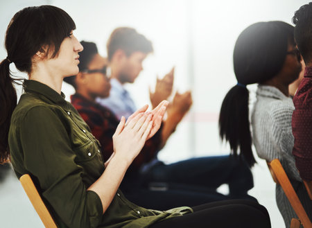 Lets give it a round of applause. Shot of a group of businesspeople clapping their hands during a presentation in a conference room.の写真素材