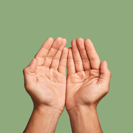 Hands, welfare and poverty with a man in studio on a green background begging for help or support....