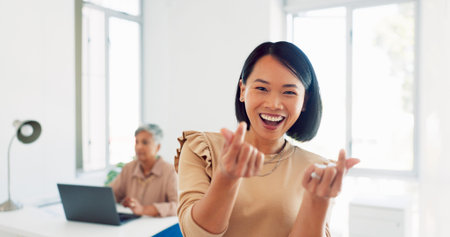 Creative asian woman, smile and peace signs walking into the office for happy, excited or positive vibes. Employee Japanese woman showing heart shape hand emoji and smiling in positivity for startupの写真素材