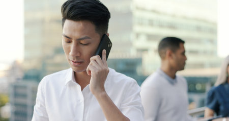 Businessman, work phone call and communication with networking, b2b and professional discussion in Tokyo. Talking, business deal and negotiation with lawyer and phone conversation, technology and 5g.の写真素材