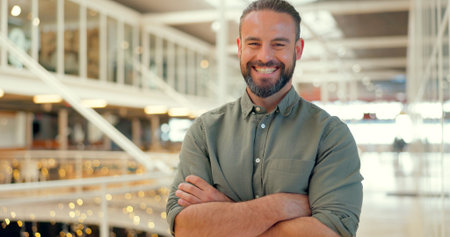 Business man, happy and arms crossed portrait while in office as leader with motivation. Smile of entrepreneur person at creative workplace for management vision, development and company growthの写真素材