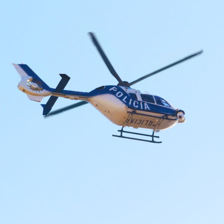 Surveying the area. Low angle shot of a police helicopter in the sky.の写真素材