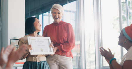 Applause, award and success with business woman in meeting for goal, thank you and winner. Celebration, praise and promotion with business people and certificate for support, achievement and brandingの写真素材