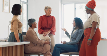 Business women, diversity and conversation with collaboration and business meeting with team in workplace. Business people, talking and listening with teamwork, communication and team buildingの写真素材