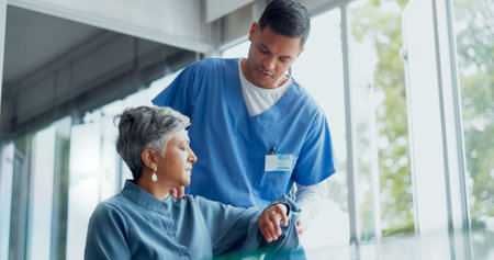 Nurse, senior woman and physiotherapy for arm injury at hospital or clinic. Rehabilitation, physical therapy or elderly female with arthritis consulting male medical professional for recovery or helpの写真素材