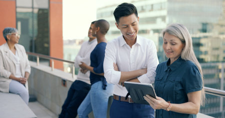 Business people diversity, tablet or office balcony in digital marketing research, strategy planning or calendar management. Mature ceo, talking manager or internship training schedule on technologyの写真素材