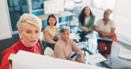Presentation, speaker woman and business people planning, budget strategy or company agenda in a meeting. Leadership, gender equality and diversity of boss, manager or presenter talking to employeesの写真素材