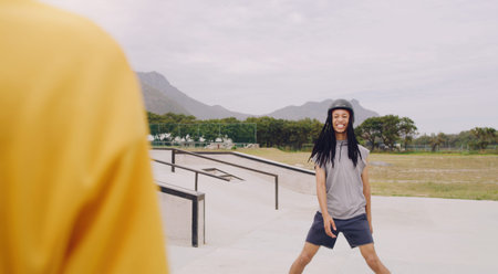 Black man at skate park, sports outdoor with gen z youth, happy and freedom, skating with helmet for...